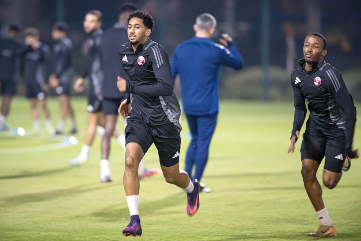 Qatar's Homam Al Amin (centre) trains with teammates. 