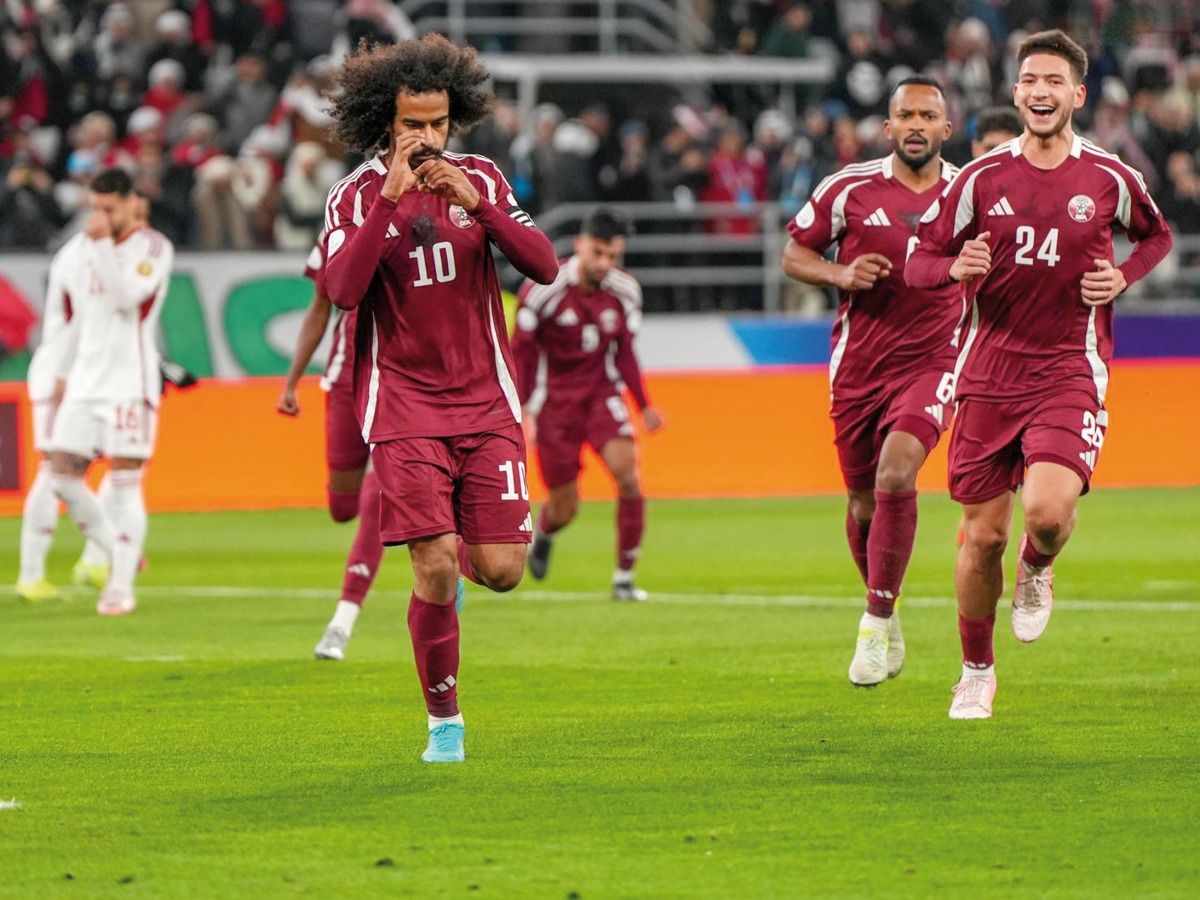 Qatar's Akram Afif (left) celebrates with teammates after scoring a goal against UAE.