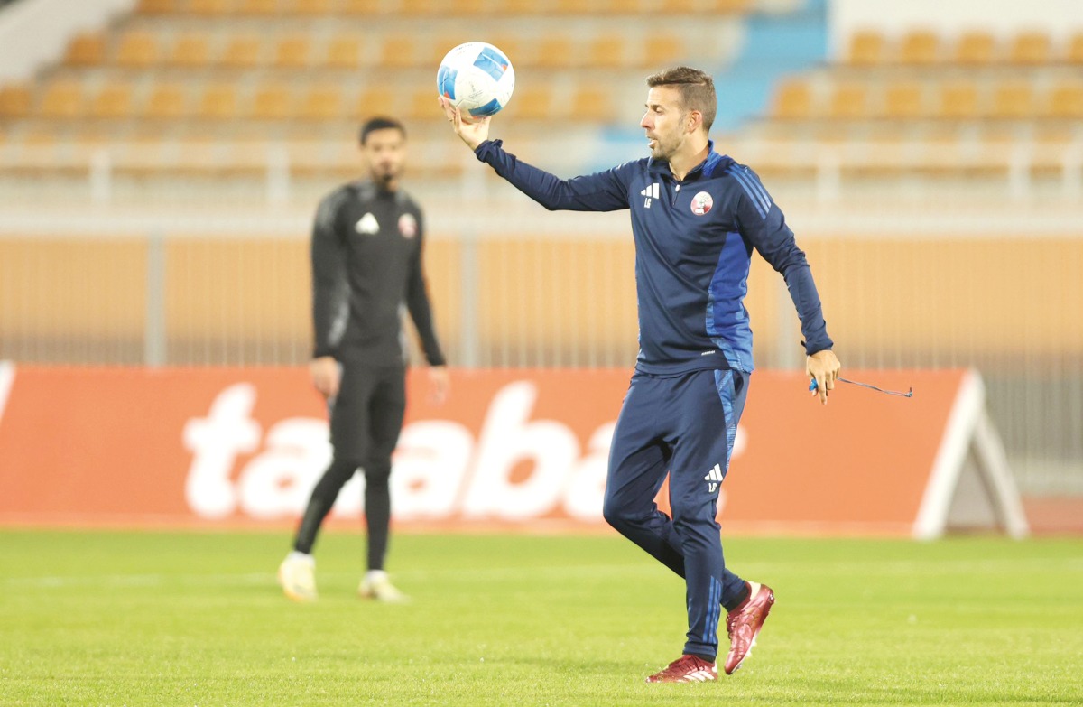 Qatar coach Luis Garcia leads training session yesterday.