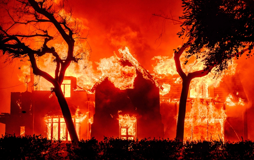 A home is engulfed in flames during the Eaton fire in the Altadena area of Los Angeles County, California on January 8, 2025. (Photo by Josh Edelson / AFP)

