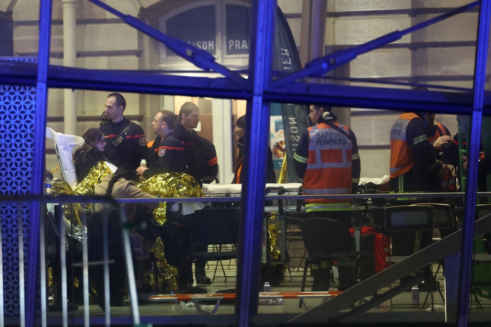 Firefighters tend to injured passengers at the Strasbourg railway station following a collision of two trams, in Strasbourg, eastern France, on January 11, 2025. (Photo by Frederick Florin / AFP)