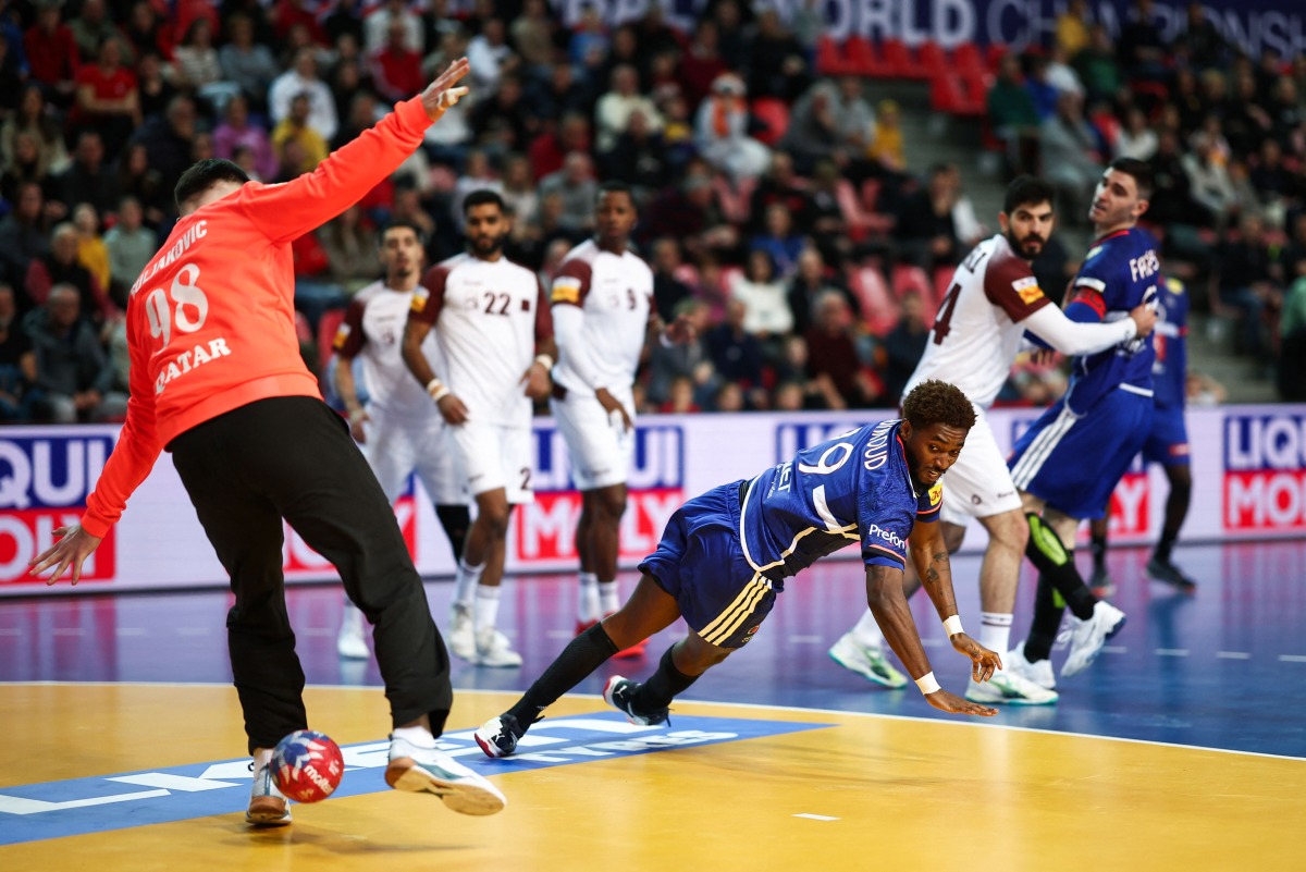 France’s Benoit Kounkoud shoots to score a goal against Qatar.