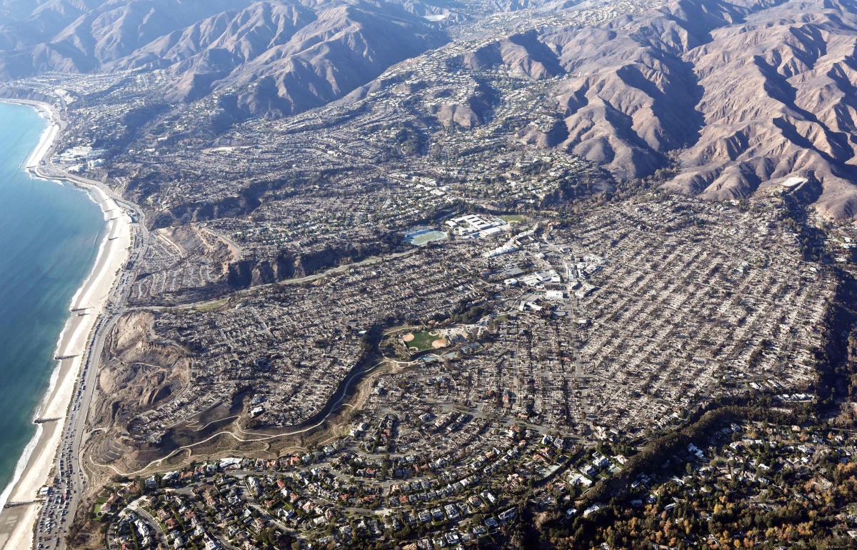 An aerial view of homes destroyed in the Palisades Fire as wildfires cause damage and loss through the LA region on January 13, 2025 in Pacific Palisades, California. Photo by MARIO TAMA / GETTY IMAGES NORTH AMERICA / Getty Images via AFP