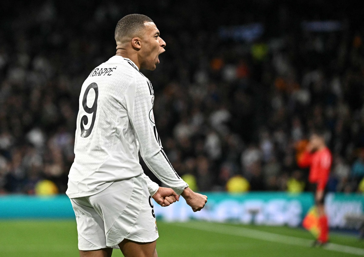 Real Madrid's French forward #09 Kylian Mbappe celebrates scoring his team's first goal during the Spanish Copa del Rey (King's Cup) last 16 first leg football match between Real Madrid CF and RC Celta de Vigo at the Santiago Bernabeu stadium in Madrid on January 16, 2025. (Photo by JAVIER SORIANO / AFP)
