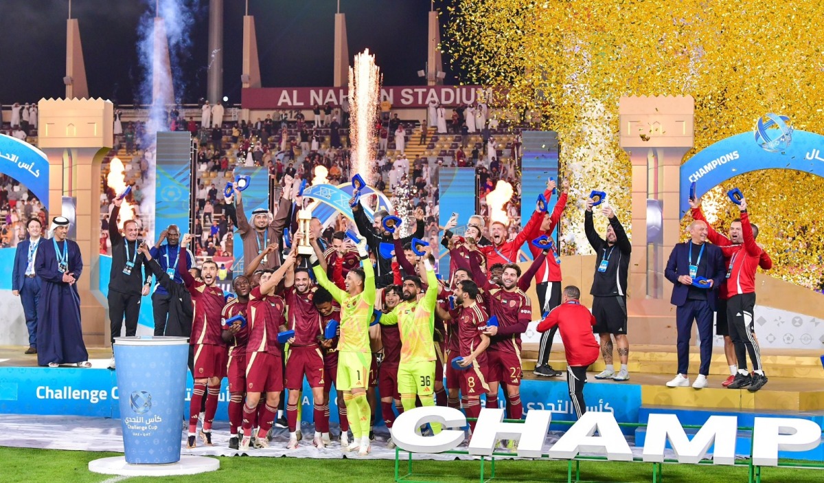 Al Wahda players and officials celebrate after winning the Qatar-UAE Super Cup Challenge Cup.