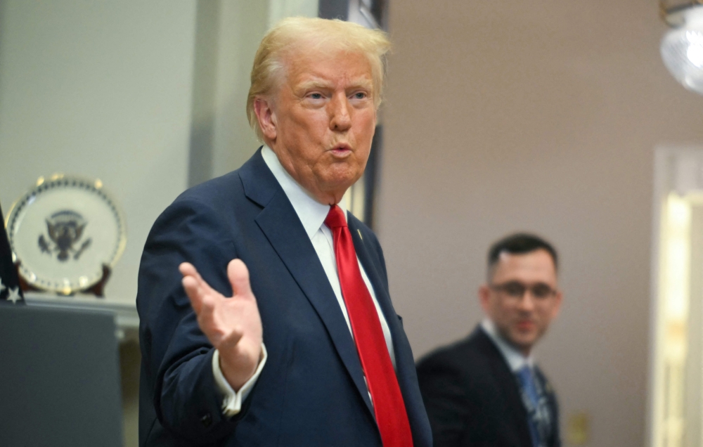 US President Donald Trump gestures as he leaves after speaking at the White House on January 21, 2025, in Washington, DC. (Photo by Jim Watson / AFP)