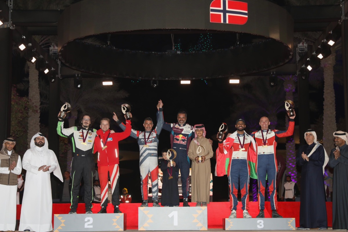 Qatar Motor & Motorcycle Federation (QMMF) President Abdulrahman bin Abdullatif Al Mannai (right) and QMMF Executive Director Amro Al Hamad (left) with other officials and top three finishers at the 2025 Qatar International Rally.