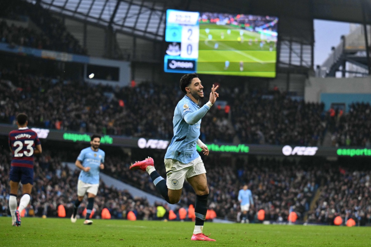 Manchester City's Egyptian striker #07 Omar Marmoush (C) celebrates after scoring his and City's third goal during the English Premier League football match between Manchester City and Newcastle United at the Etihad Stadium in Manchester, north west England, on February 15, 2025. (Photo by Oli SCARFF / AFP)