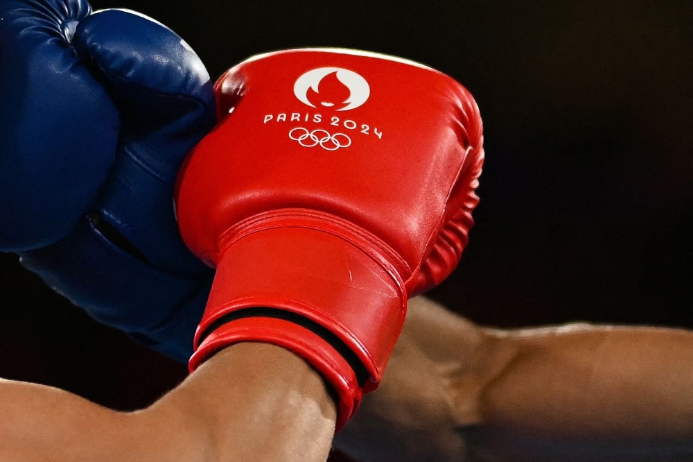 File: Kyrgyzstan's Munarbek Seiitbek Uulu and Bulgaria's Javier Ibanez Diaz (blue) competed in the men's 57kg semi-final boxing match during the Paris 2024 Olympic Games at the Roland-Garros Stadium, in Paris on August 8, 2024. (Photo by Mauro Pimentel / AFP)