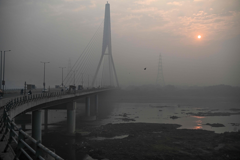 (Files) A general view shows the Signature Bridge over the Yamuna River on a smoggy winter morning in New Delhi on December 20, 2024. (Photo by Arun Sankar / AFP)