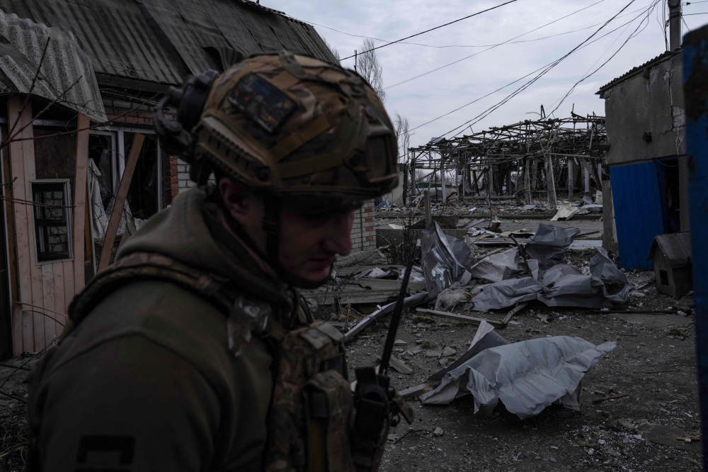 In this handout photograph taken on March 13, 2025 and released on March 14, 2025 by the press service of the 93rd Kholodnyi Yar Separate Mechanized Brigade of the Ukrainian Ground Forces, a Ukrainian serviceman stands among debris in an abandoned area in Pokrovsk, Donetsk region, amid the Russian invasion of Ukraine. (Photo by Handout / The 93rd Kholodnyi Yar Separate Mechanized Brigade / AFP) 