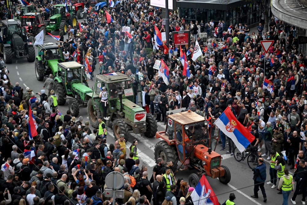 Farmers join protesters as they arrive in the capital from cities across Serbia, to take part in the largest protest since the anti-graft movement, in downtown Belgrade on March 15, 2025. (Photo by Andrej Isakovic / AFP)