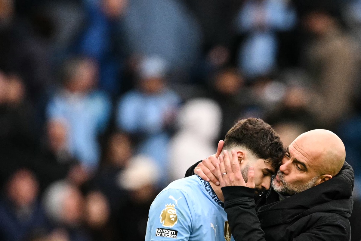 Manchester City's Spanish manager Pep Guardiola (R) kisses Manchester City's Croatian defender #24 Josko Gvardiol (L) at the end of the English Premier League football match between Manchester City and Brighton and Hove Albion at the Etihad Stadium in Manchester, north west England, on March 15, 2025.(Photo by Oli SCARFF / AFP)