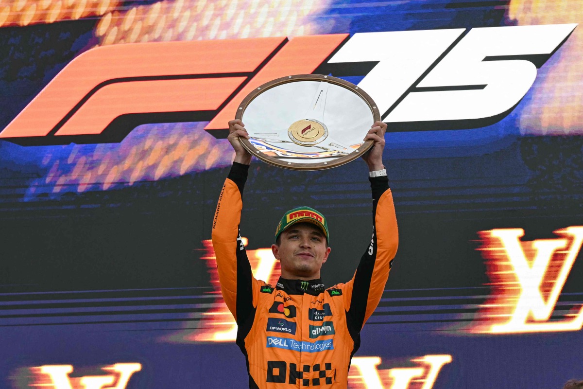 First-placed McLaren's British driver Lando Norris celebrates on the podium after the Australian Formula One Grand Prix at Albert Park Circuit in Melbourne on March 16, 2025. (Photo by Saeed KHAN / AFP)