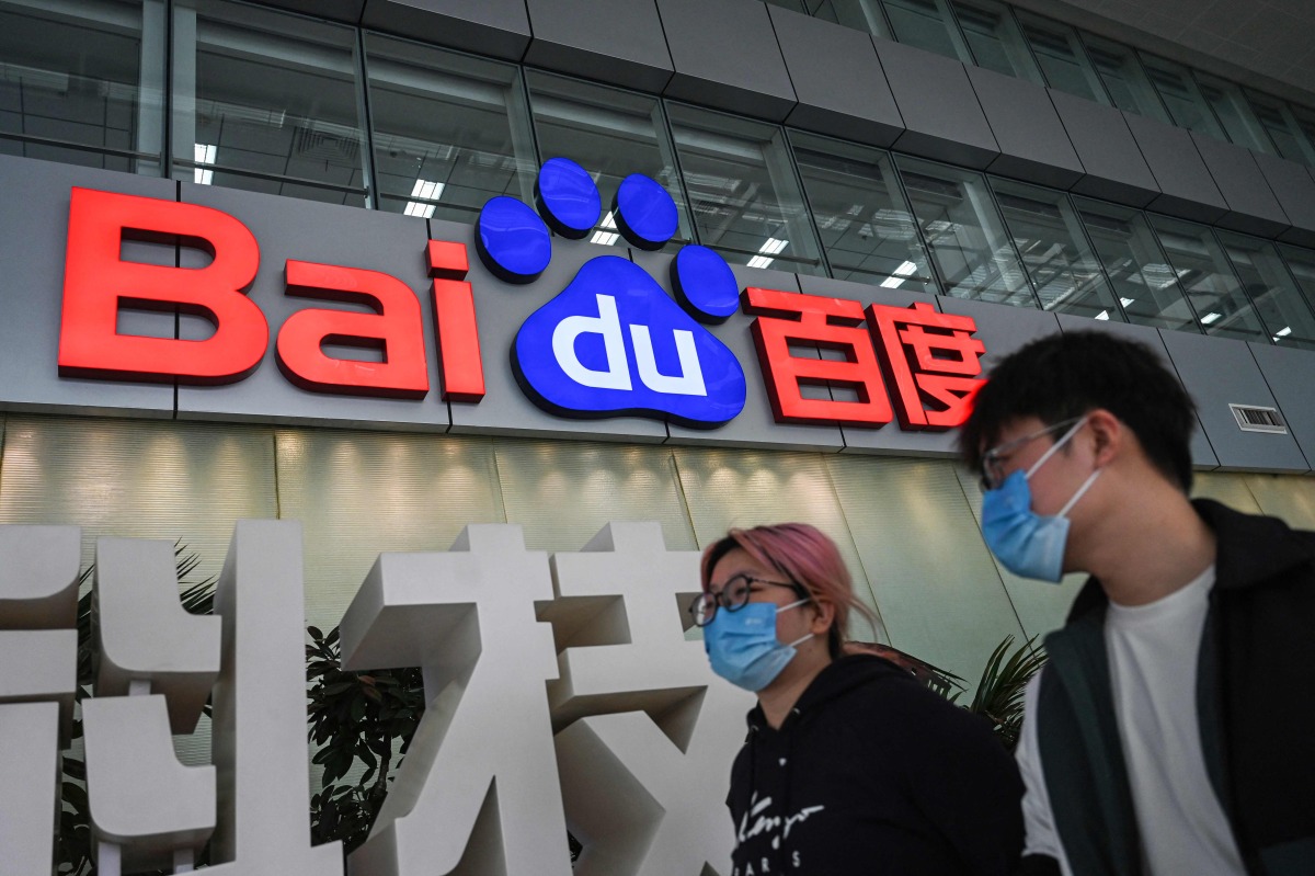 People walk past a Baidu logo outside the company headquarters in Beijing on February 2, 2024. Photo by Jade GAO / AFP