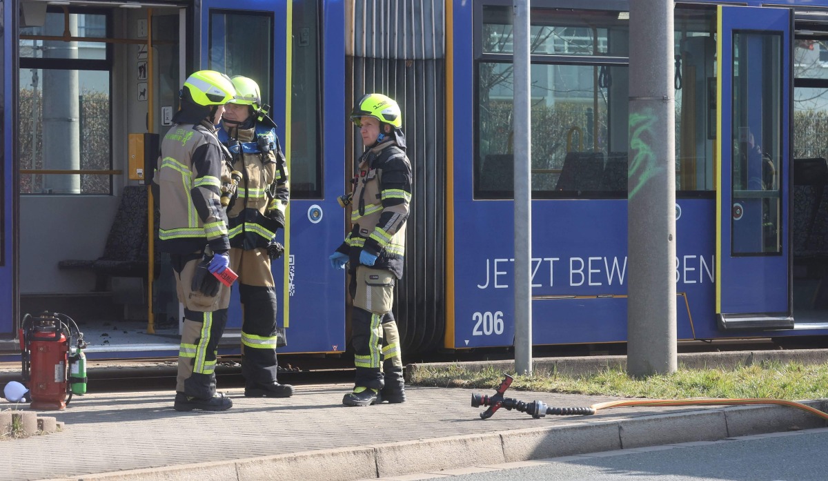 Fire fighters stand near a tram in Gera on March 16, 2025. Photo by Bodo Schackow / dpa / AFP