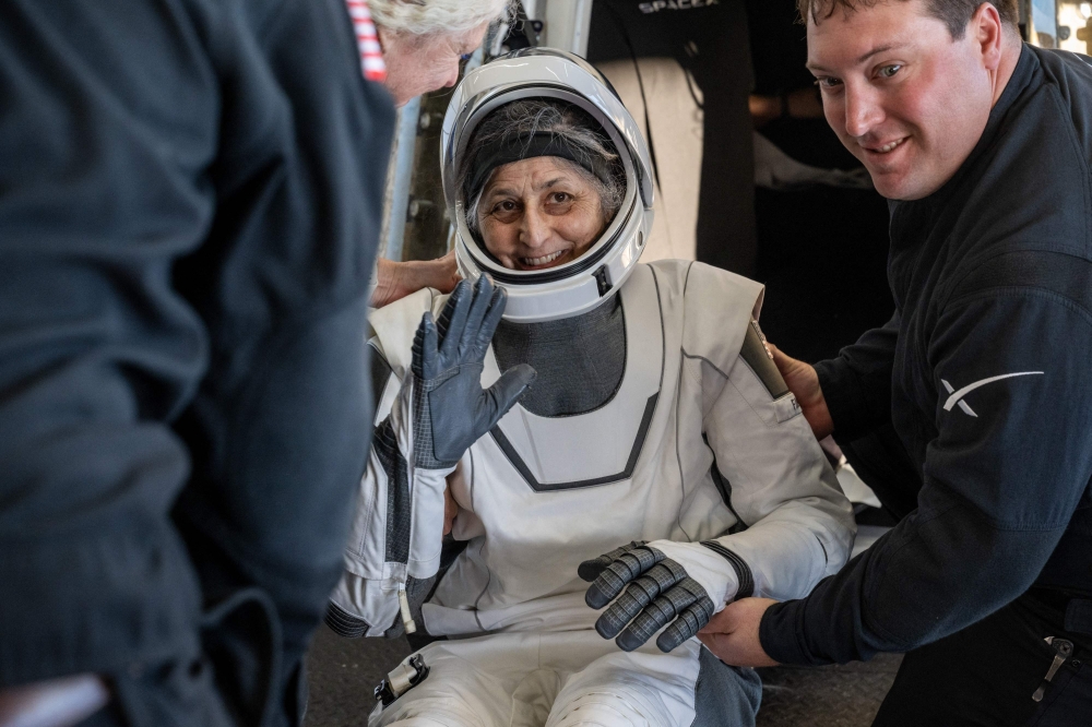 This photo provided by NASA shows NASA astronaut Suni Williams being helped out of a SpaceX Dragon spacecraft on board the SpaceX recovery ship MEGAN after she, NASA astronauts Nick Hague, Butch Wilmore, and Roscosmos cosmonaut Aleksandr Gorbunov landed in the water off the coast of Tallahassee, Florida, on March 18, 2025. (Photo by Keegan Barber / NASA / AFP)