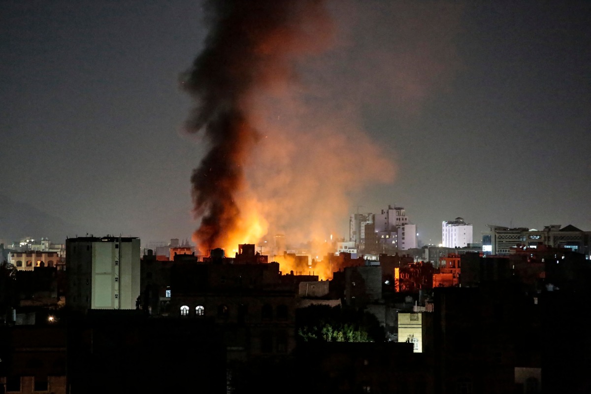 Smoke plumes rise above buildings following bombardment on Yemen's capital Sanaa on March 19, 2025. (Photo by AFP)