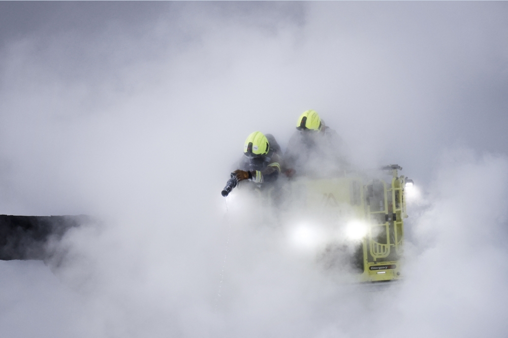 Firefighters douses flames of a fire that broke out at a substation supplying power to Heathrow Airport in Hayes, west London on March 21, 2025. (Photo by Benjamin Cremel / AFP)
