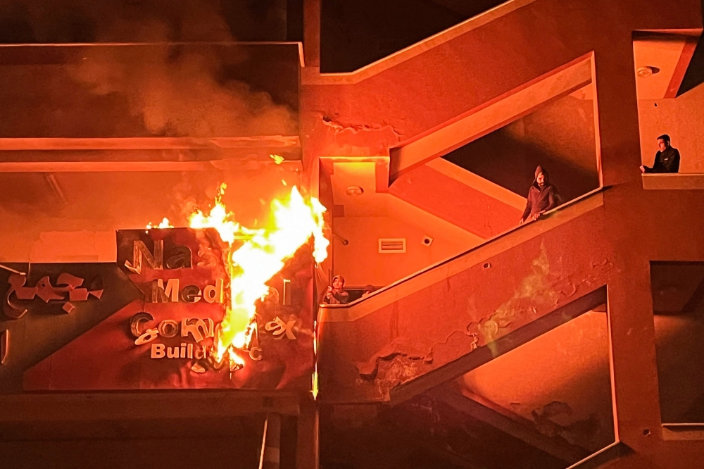 Palestinians try to put out a fire at the emergency department of the Nasser hospital after it was hit in an Israeli airstrike, in Khan Yunis in the southern Gaza Strip on March 23, 2025. (Photo by AFP)