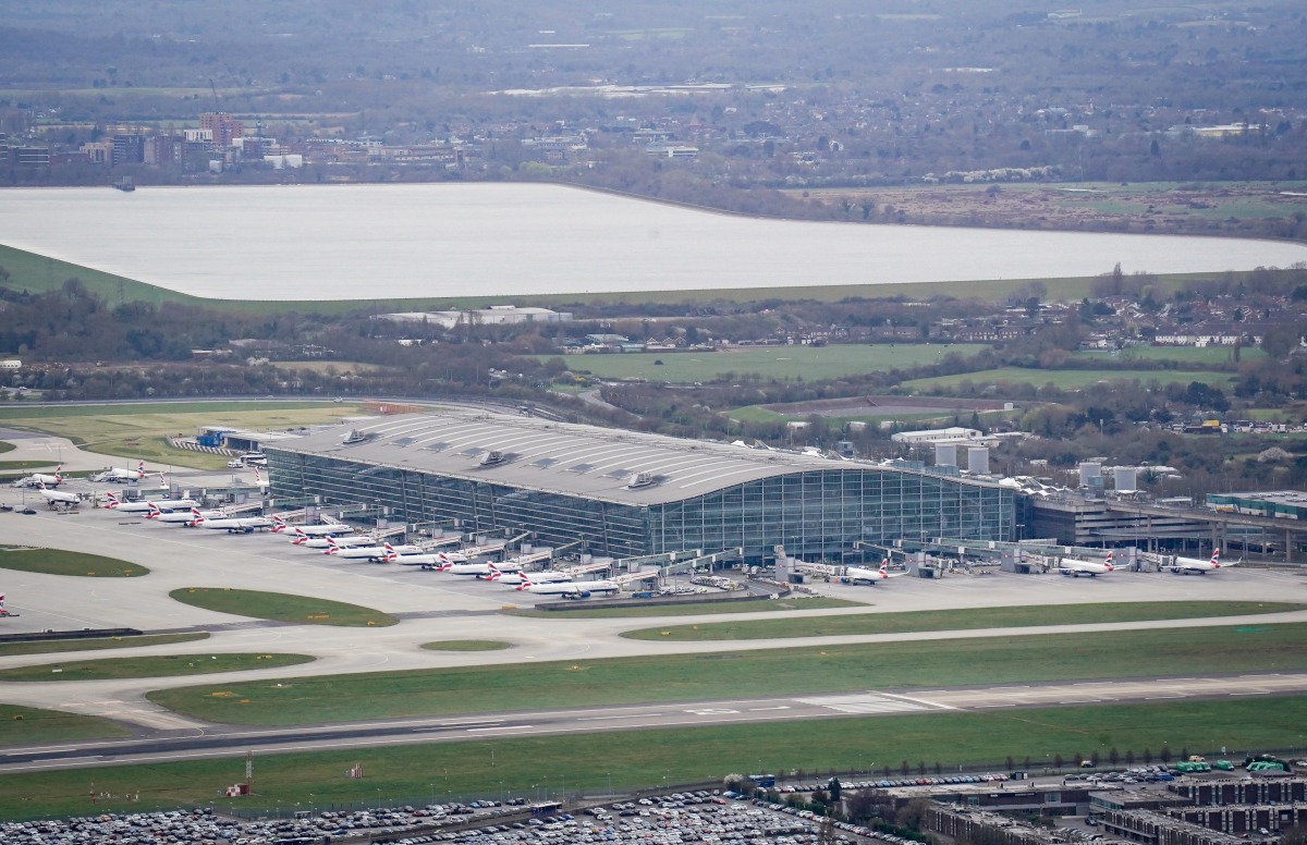 An aerial photograph taken on March 21, 2025 shows planes parked on the tarmac of Heathrow Airport following its closure after a fire broke out at a substation supplying power of the airport, in Hayes, west London. Photo by AFP