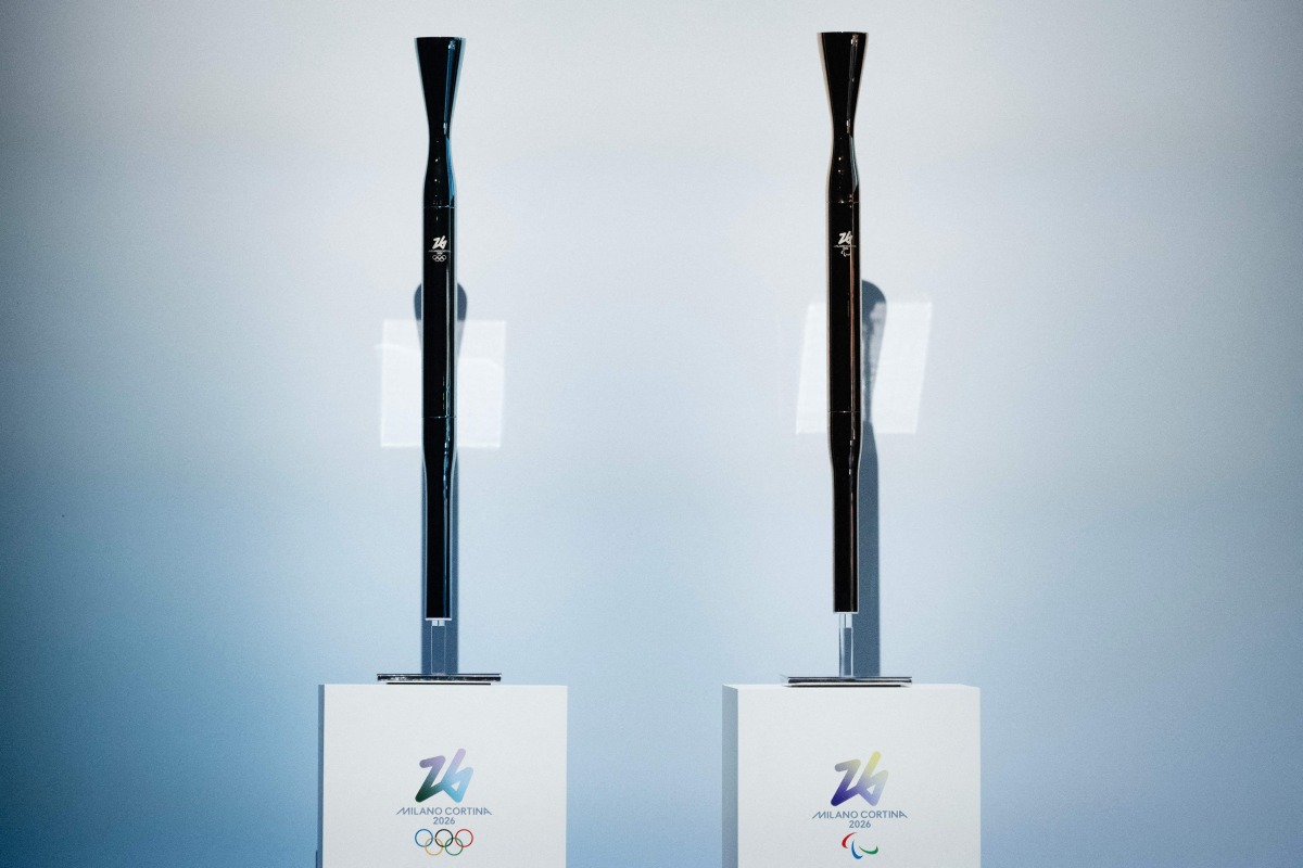A picture shows the torches for the Milano Cortina 2026 winter olympic (L) and paralympic (R) games during the unveiling ceremony in Milan on April 14, 2025. (Photo by MARCO BERTORELLO / AFP)